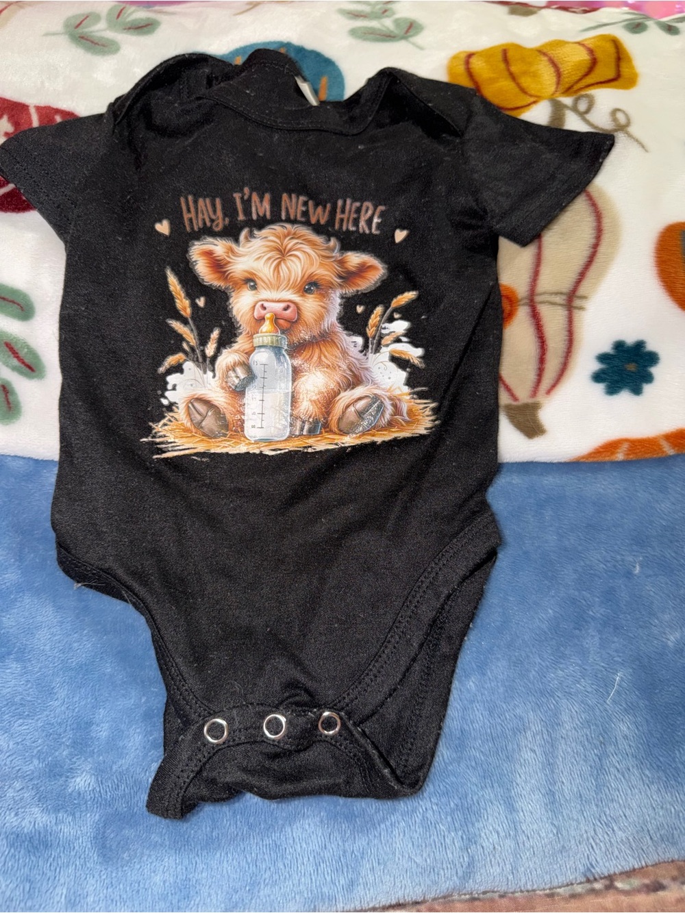 Black Baby One-Piece Bodysuit with 'Hay, I'm New Here' Calf Graphic